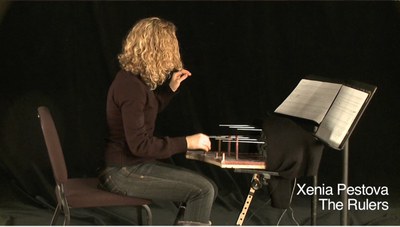Xenia Pestova sitting in front of the Rulers DMI with a music stand and notation